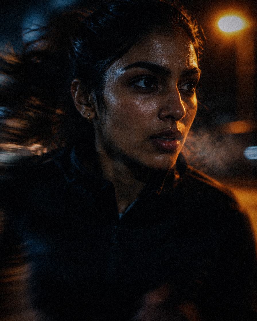 A woman mid-run at night, breath in the cold air